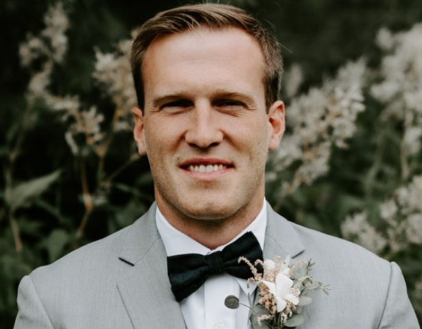 Headshot of Curt Williams smiling in a formal light gray suit