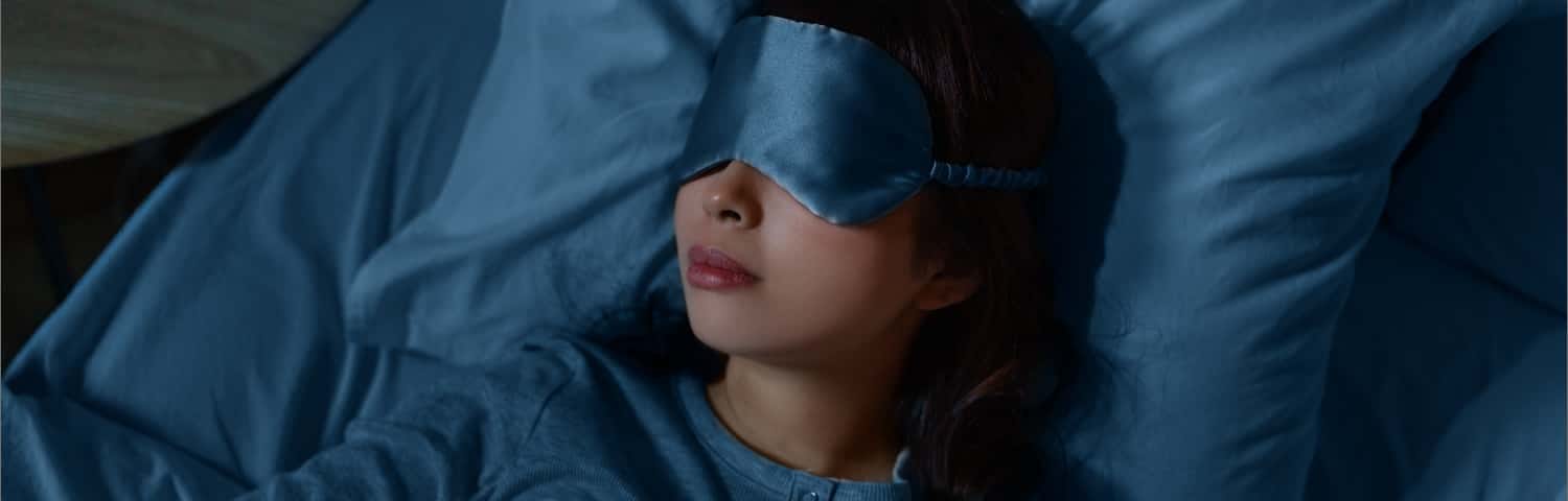 Attractive woman sleeps peacefully with eye mask on