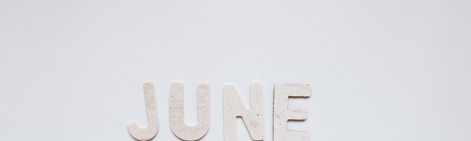 June spelled out in light tan letters on a white background.