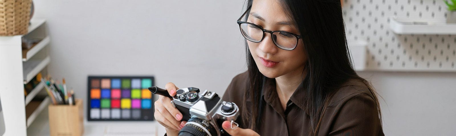 A woman looking at a camera in her home studio.