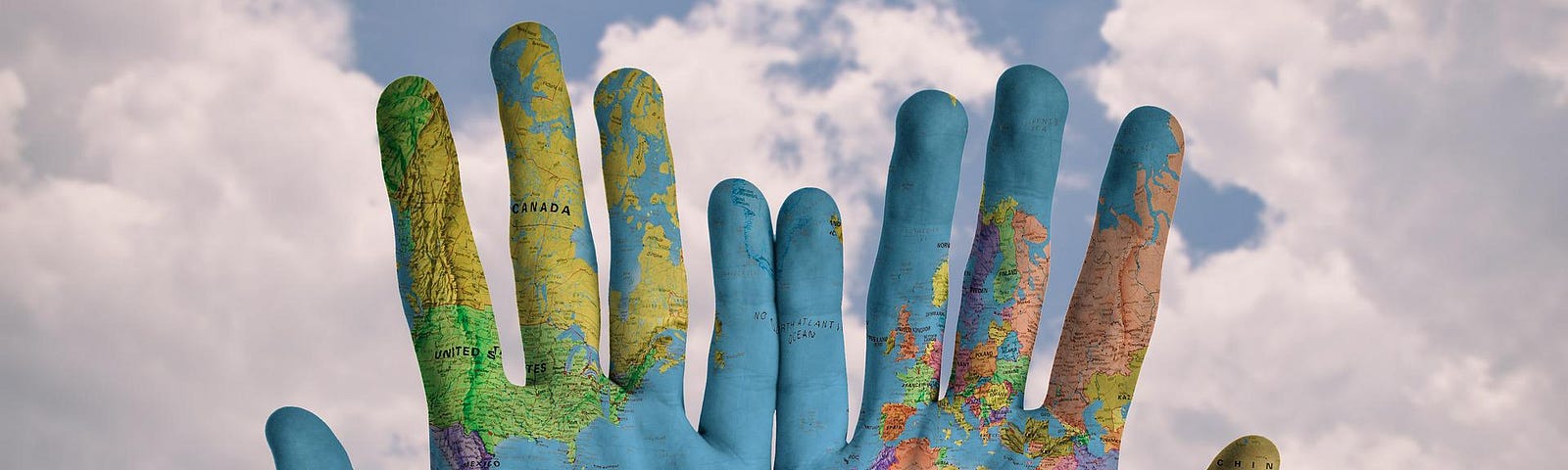 2 hands painted with a world map in color.