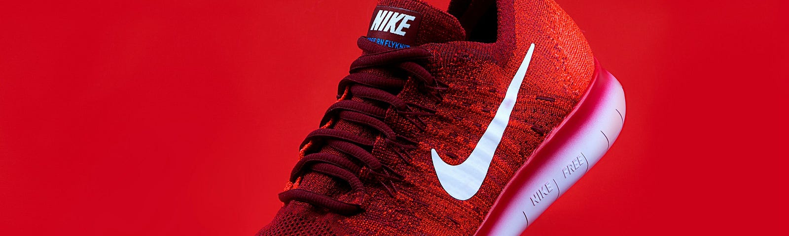 A red nike shoes on the red background representing the idea of well-known and recognizable brand