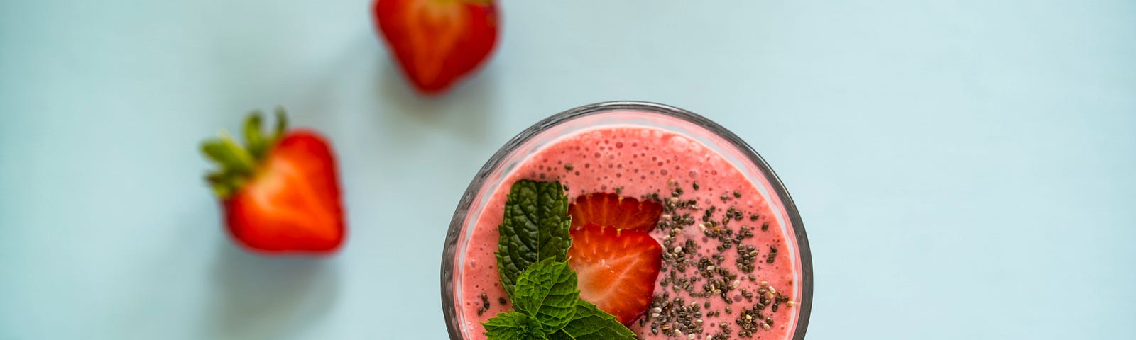 Aerial view of pink smoothie with mint leaves