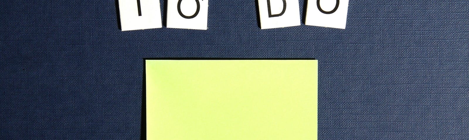 “To Do” written in Scrabble-like letters above a yellow, blank post-it note.