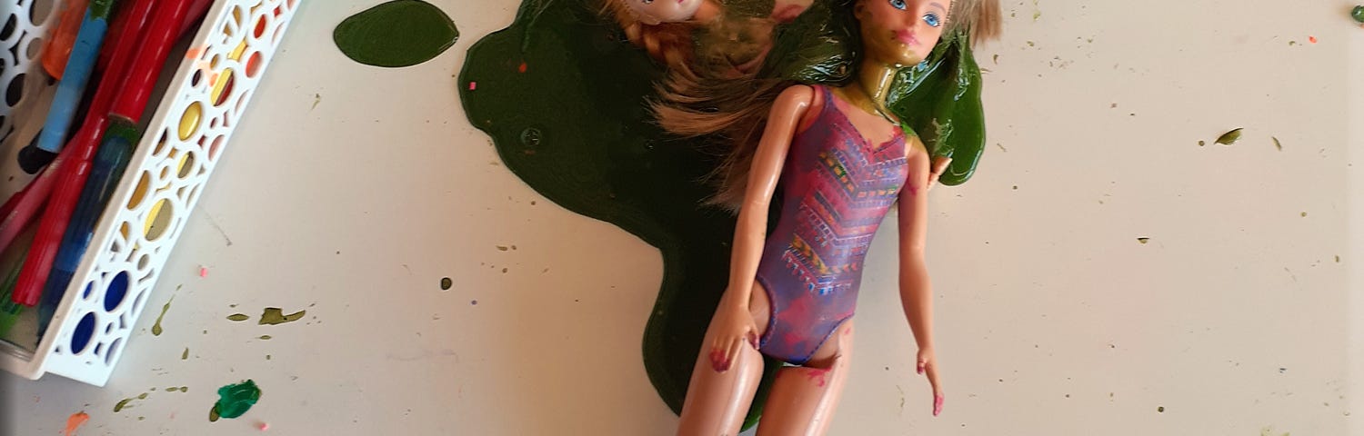 Two fashion dolls are swamped in green slime.