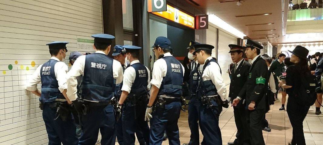 A group of Japanese police subduing a suspect