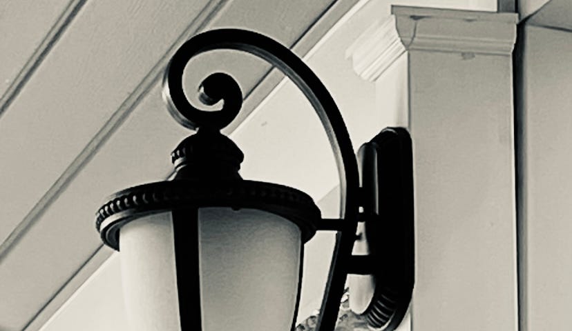 A wall sconce light in black and white.