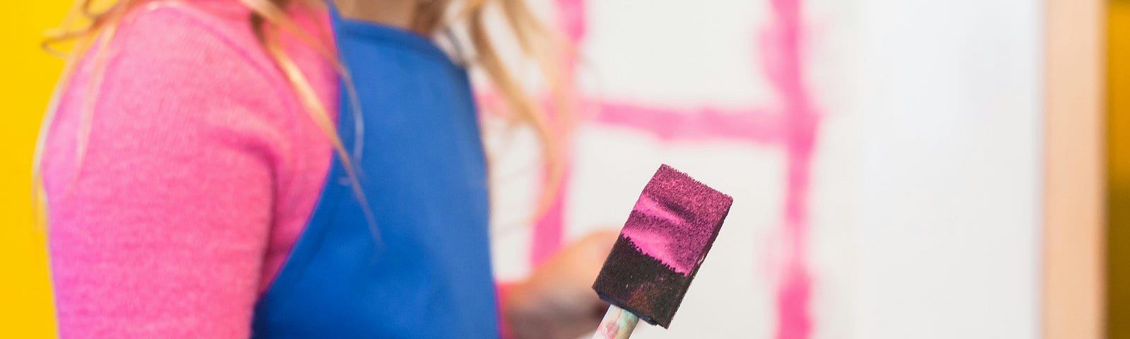 A woman painting pink