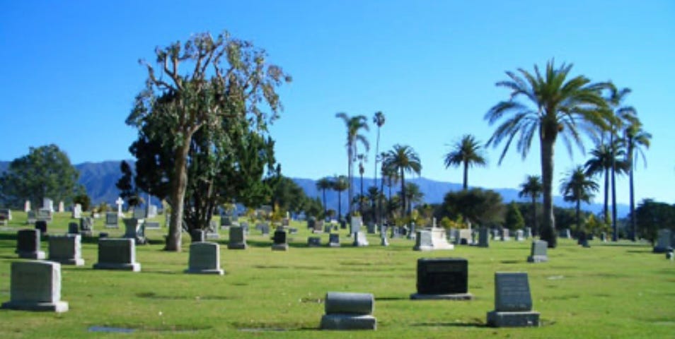 A picture of a cemetery on a beautiful day with a gorgeous blue sky in the background.