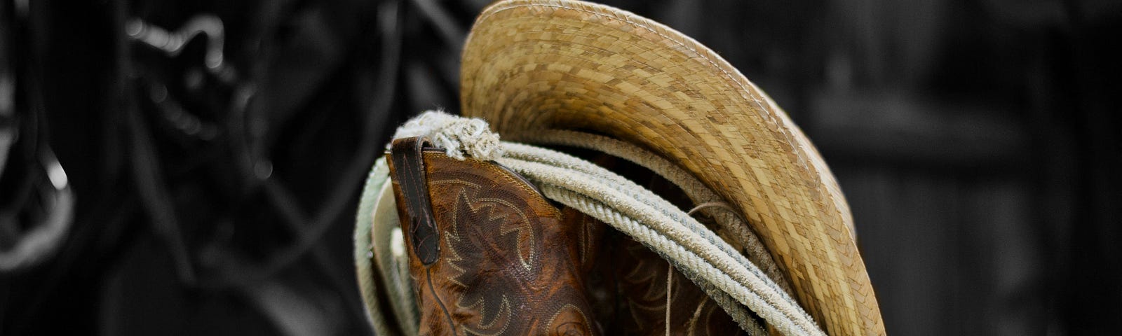 cowboy boots, a hat, and a lariat