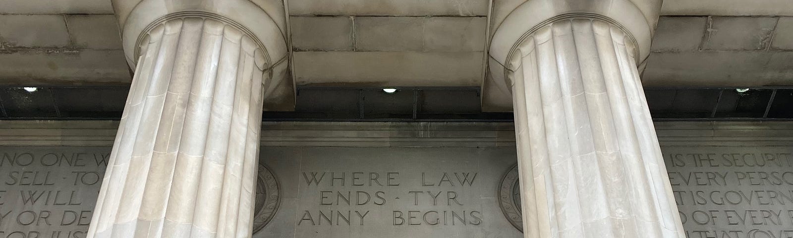 Civil Courts building with doric columns and engraving above door: “Where Law Ends Tyranny Begins.”