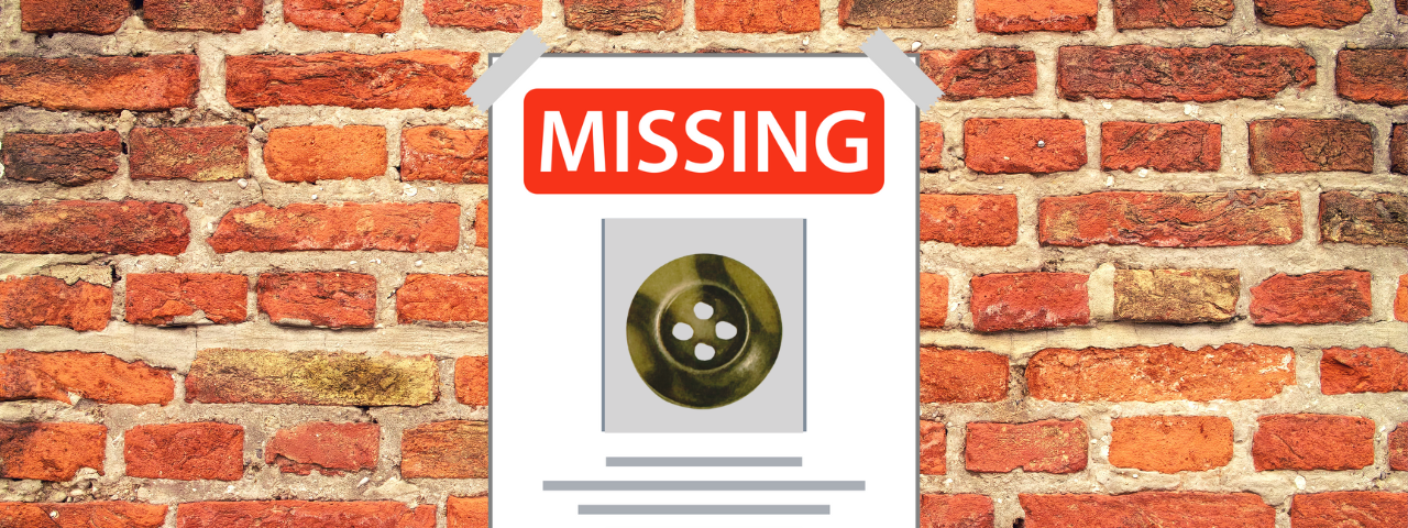 An image of a missing button poster on a red brick wall