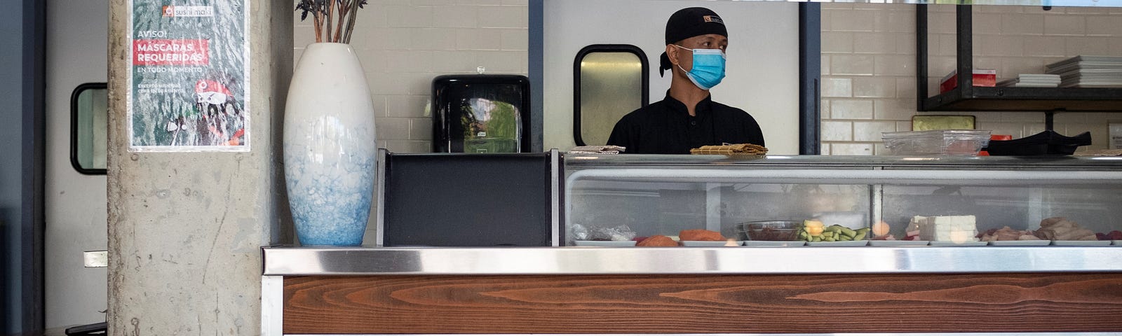 A sushi chef waits for diners in Miami, Florida, August 31, 2020. Photo by Marco Bello/Reuters