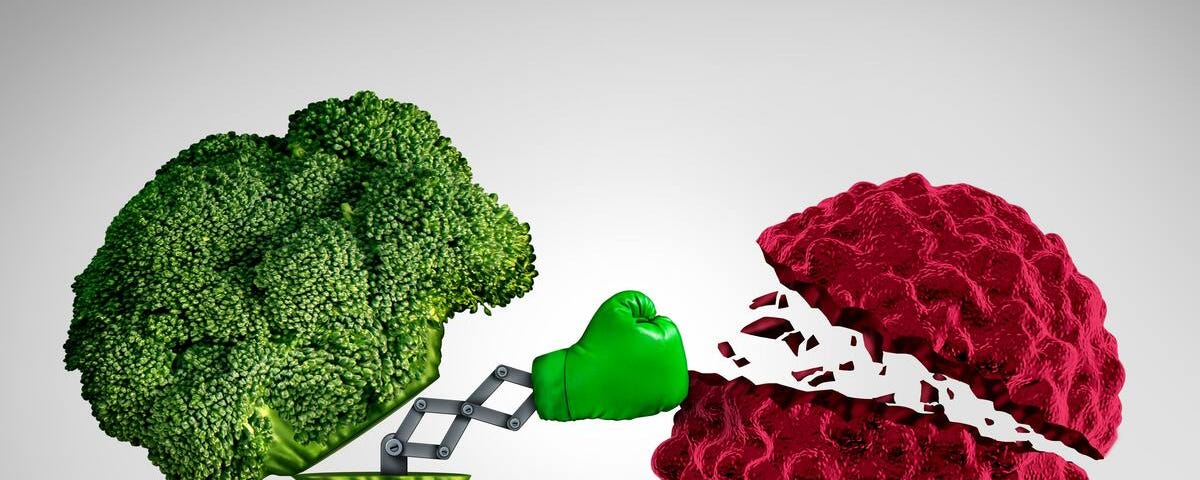 A broccoli piece knocks a virus with a boxing glove, representing how healthy foods boost the immune system.