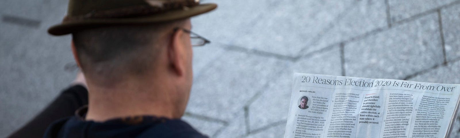 An individual reading the newspaper.