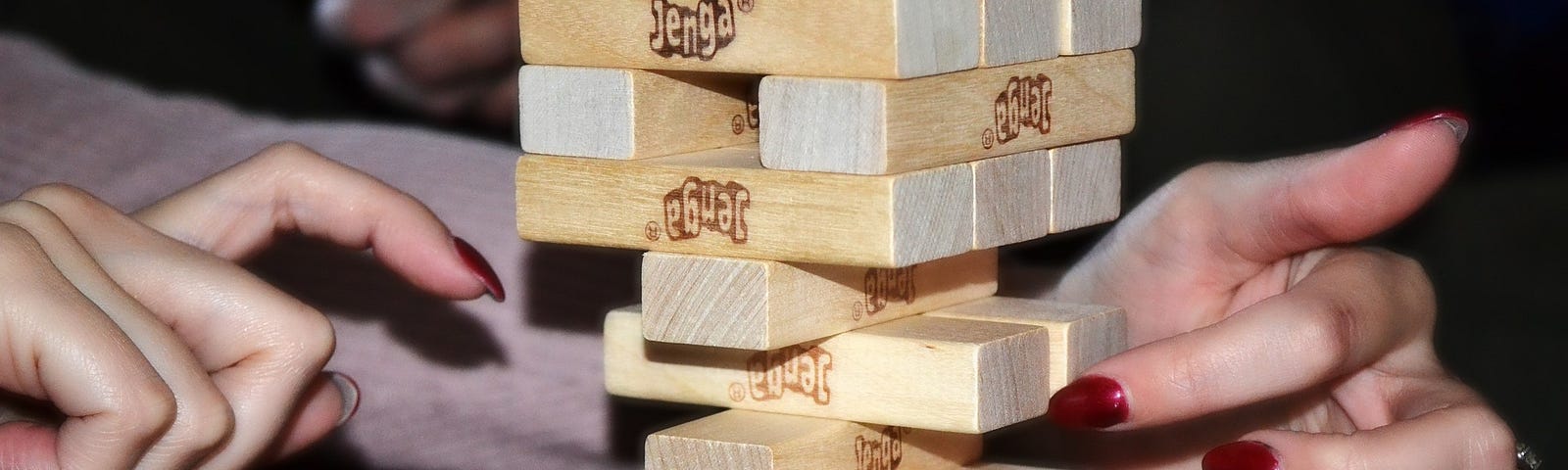 Jenga game with the blocks close to tipping over