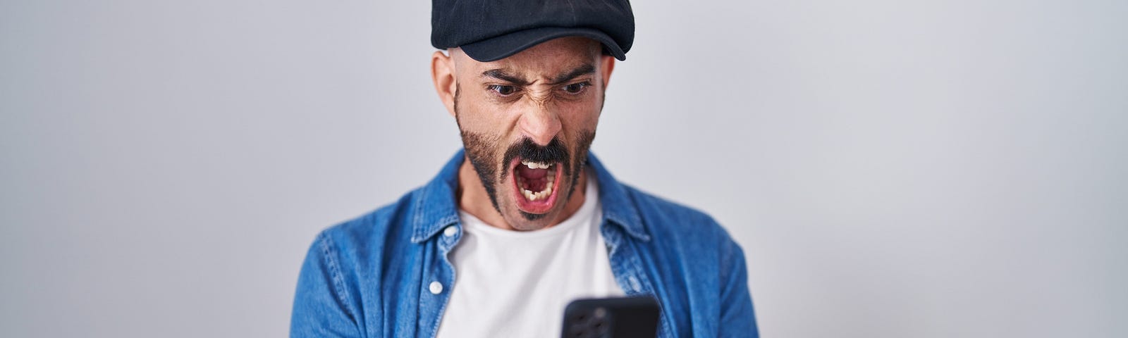An angry man on his cell phone fexting
