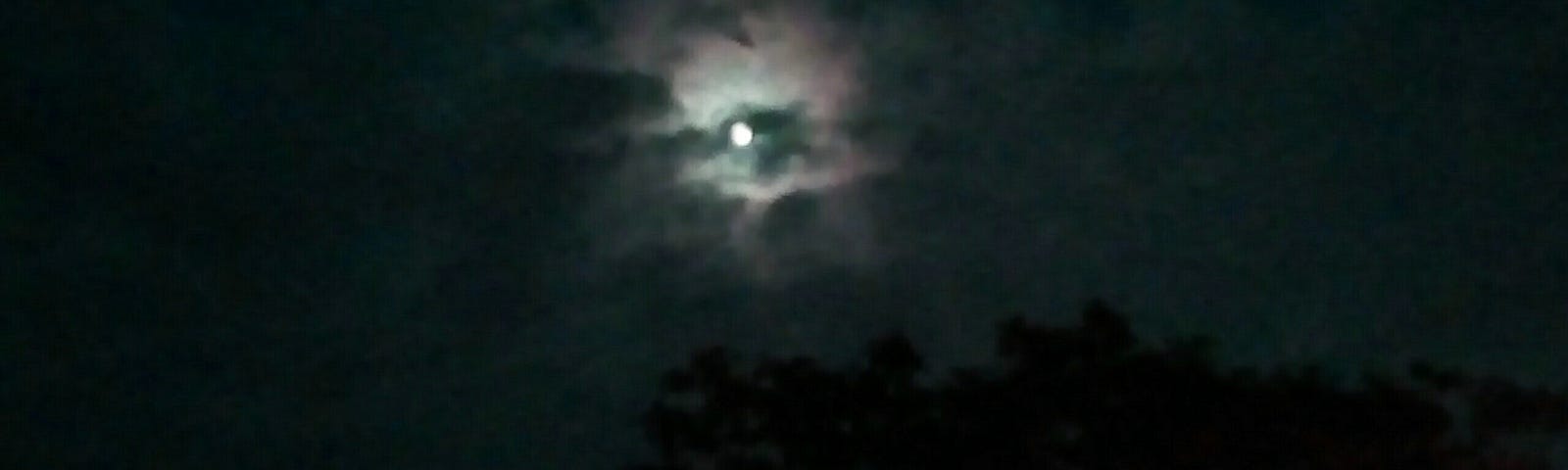 Bright full moon with green undertones.