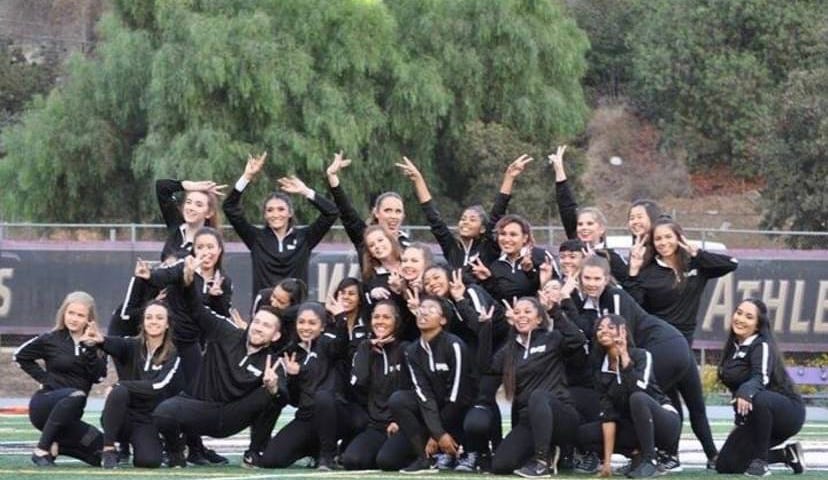 Photo of the Whittier College Dance Team posing on the football field.