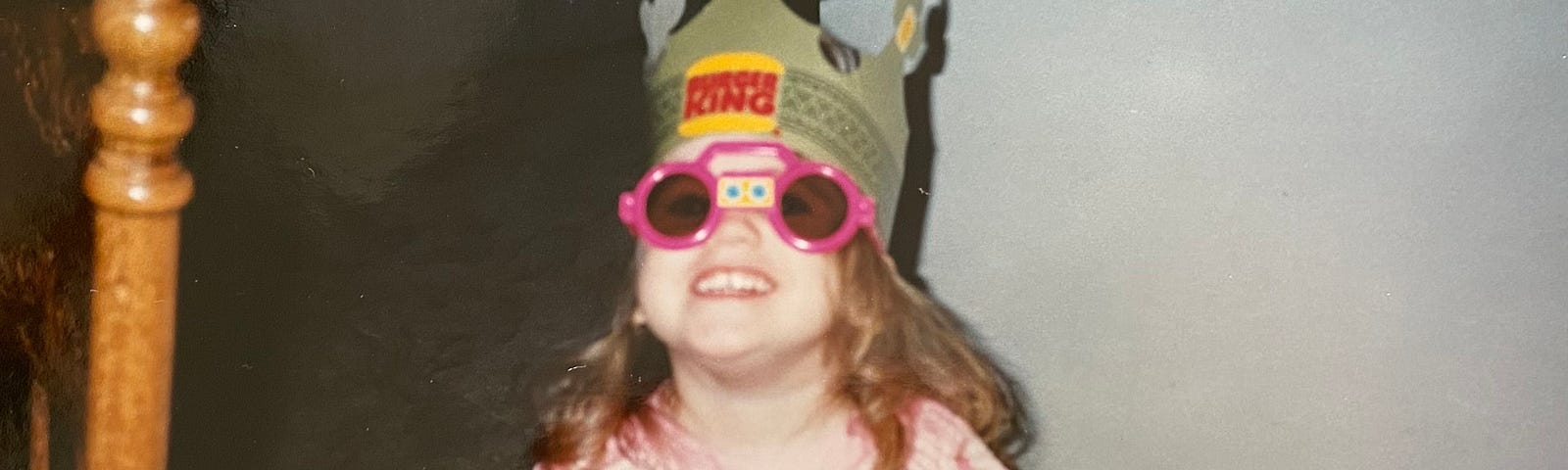 Donning a Burger King crown from the ’90s, I flash a cheesy grin behind children’s sunglasses.