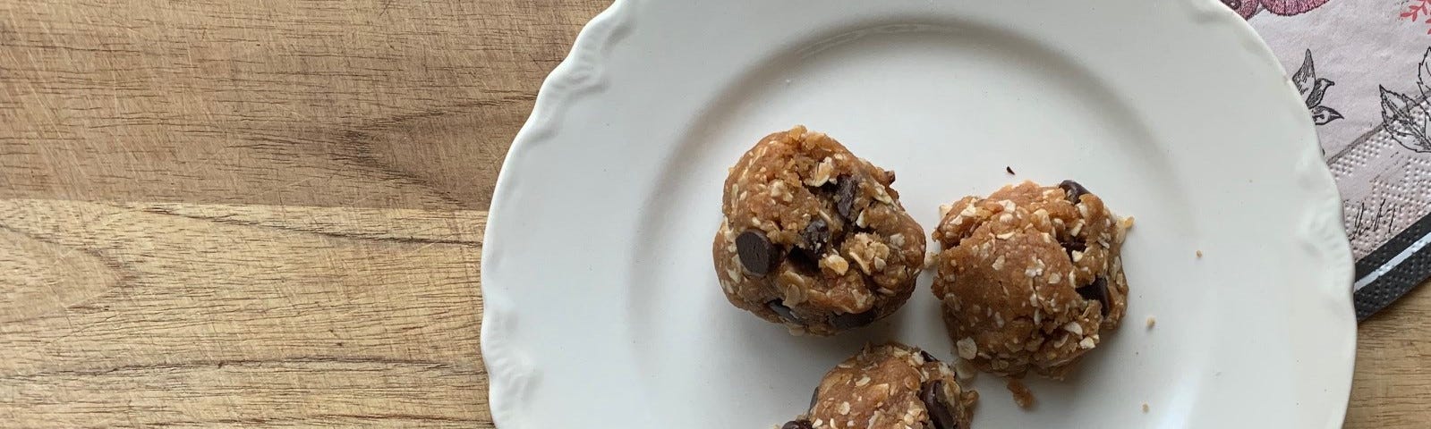 Three cookies of the cookies made by author, resting on an old-fashioned cream coloured plate.