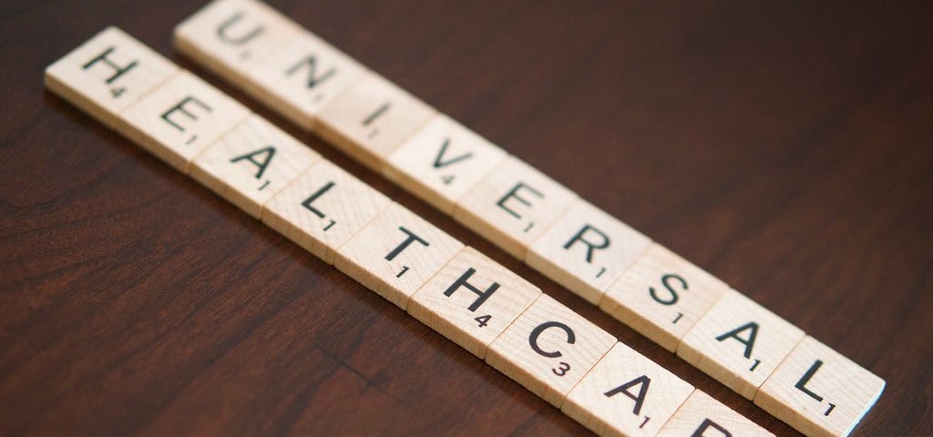 Scrabble letters spelling UNIVERSAL HEALTHCARE