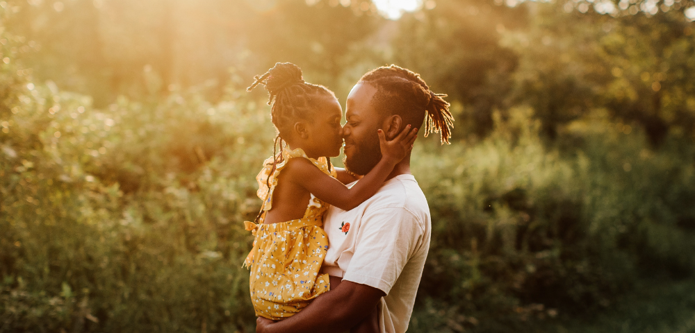 Person holding child in nature