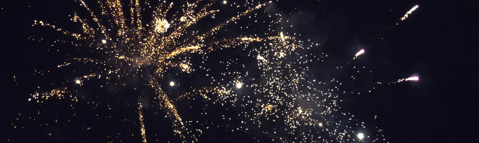 fireworks exploding in a night sky