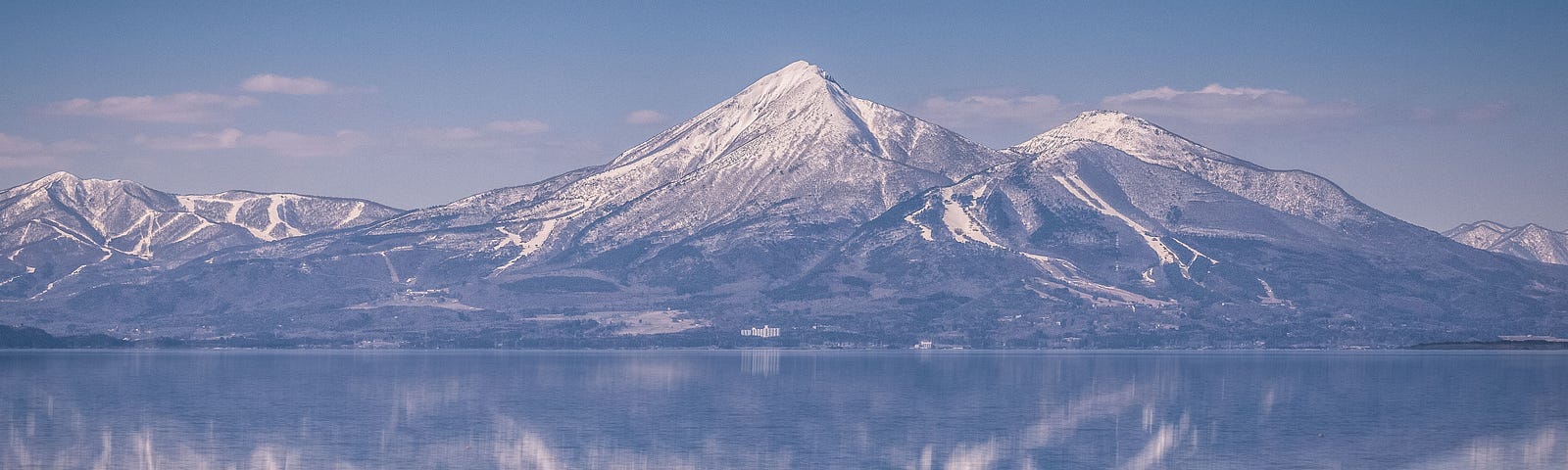 Snow-capped Mount Bandai reflected in the still waters of Lake Inawashiro, Fukushima.