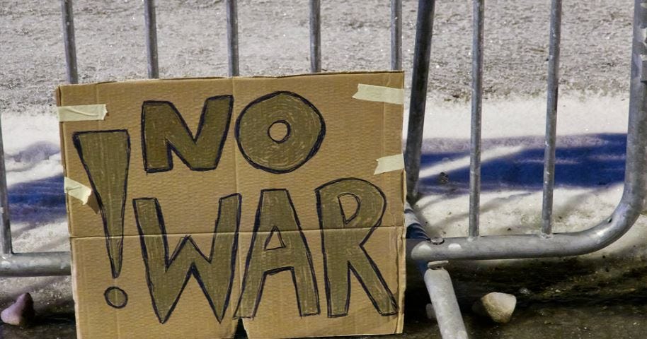 A protest sign reading ‘no war’