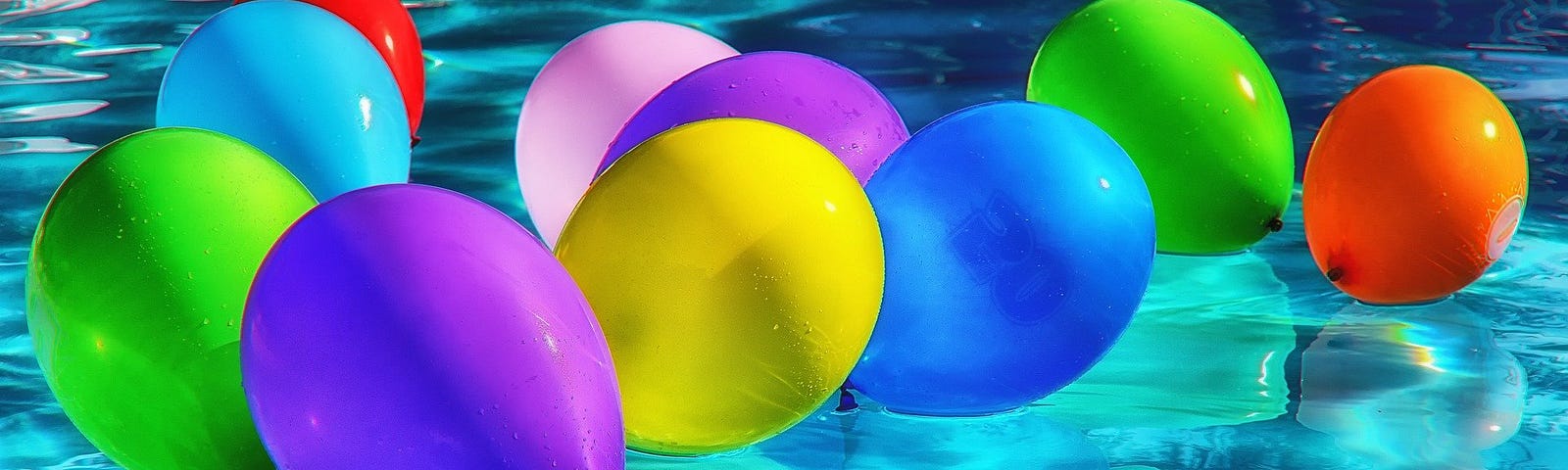 multicolored balloons hovering over water