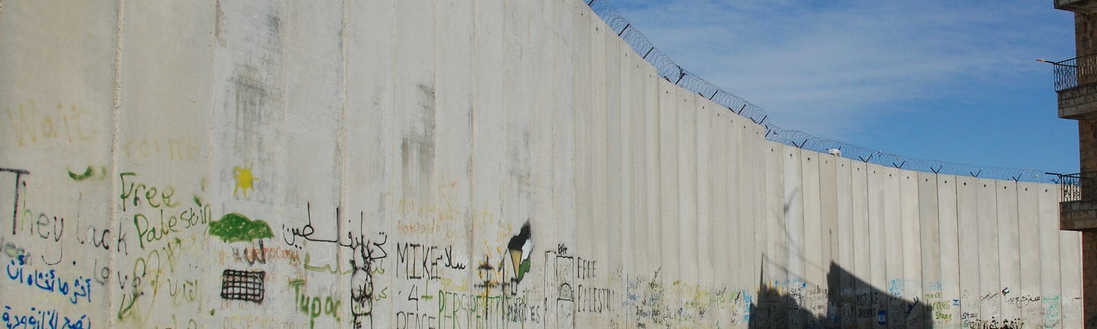 ‘Free Palestine,’ on a section of the Israeli Apartheid Wall sealing the village of Bir Nabala from the main road to Jerusalem. Cropped from the photo used in the cover of Ramsey Hanhan’s book, Fugitive Dreams. (Photo by the author, 2013).