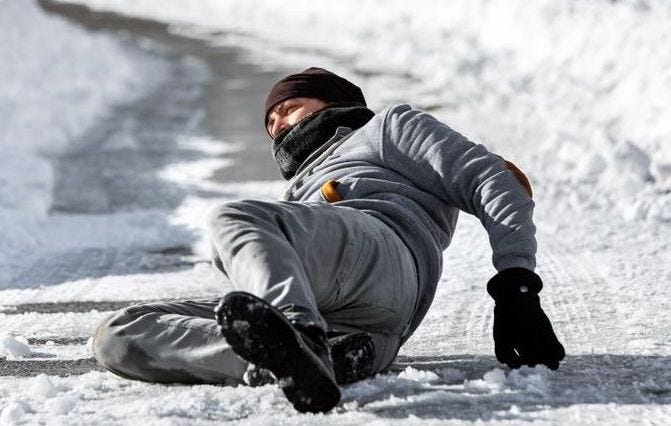 A man slipped on an icy road. He seems in pain.