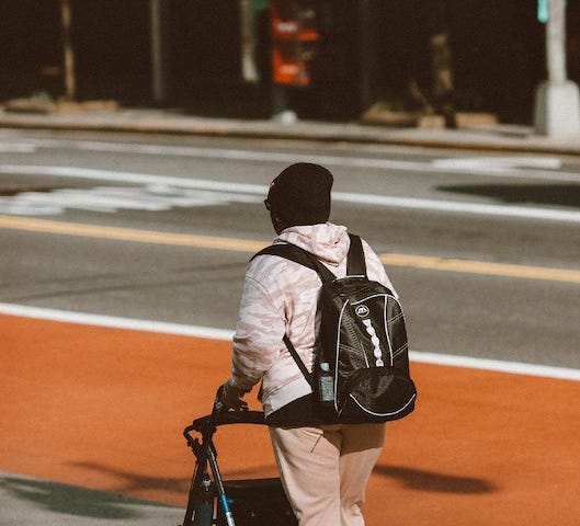 Man with backpack using a wallker