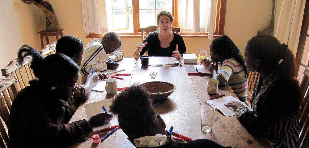 The author with students at a table