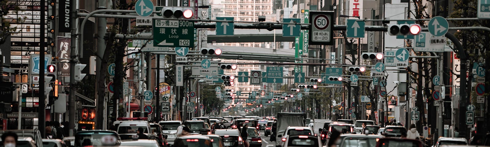 A city street in Japan crowded with automobile traffice.