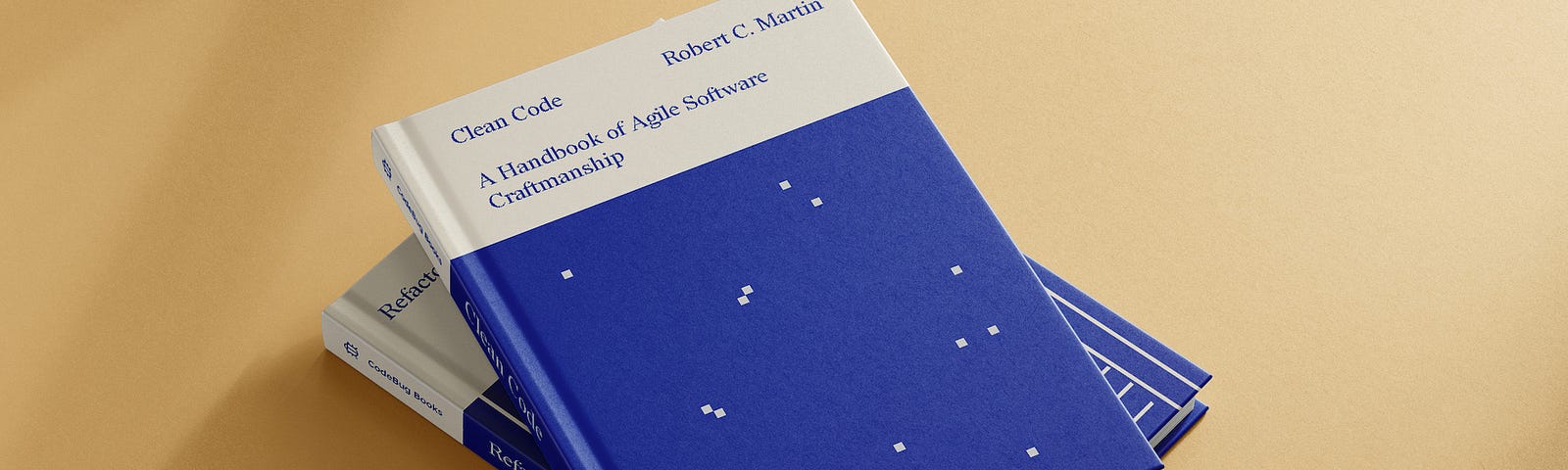 Mockup of two books, one on top of the other. On the top is ‘Clean Code’ by Robert C. Martin. It showcases the cover, redesigned by María Simó, on cream and electric blue tones and some dots resembling pixels or constellations.