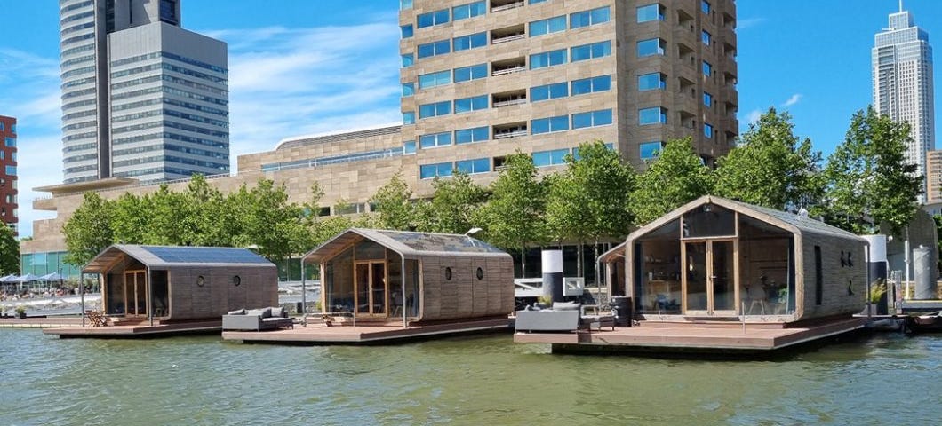 A view of a few Wikkelboat sustainable tiny homes as seen from the water.