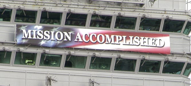 “Mission Accomplished” sign hung from U.S. Navy ship.