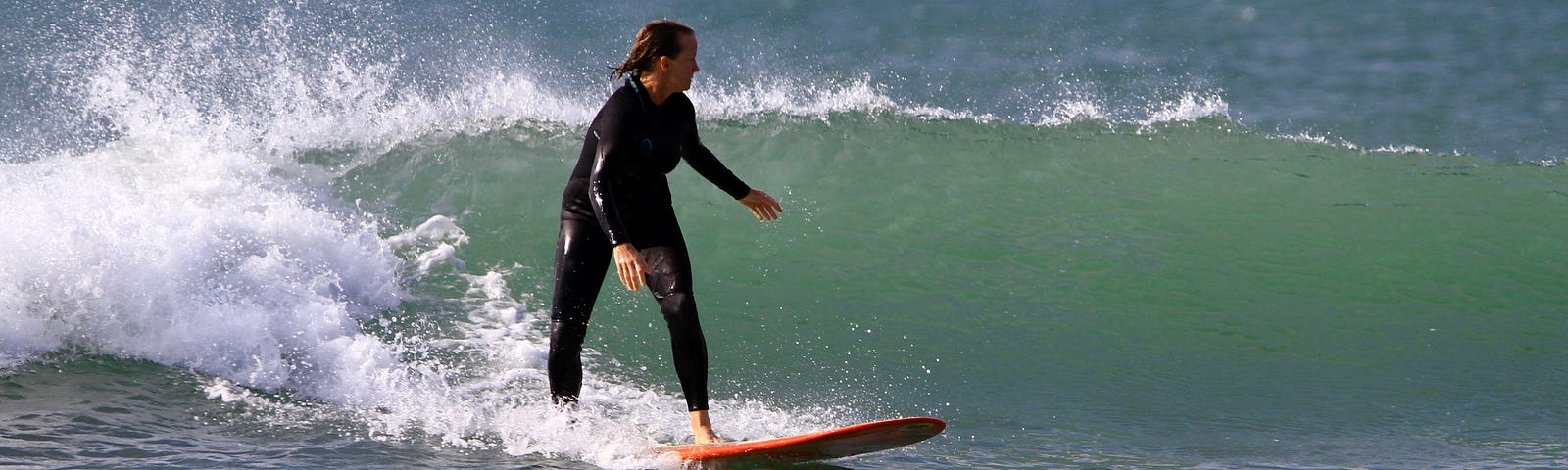 Woman longboard surfer in Peru, left hander wave, Lobitos