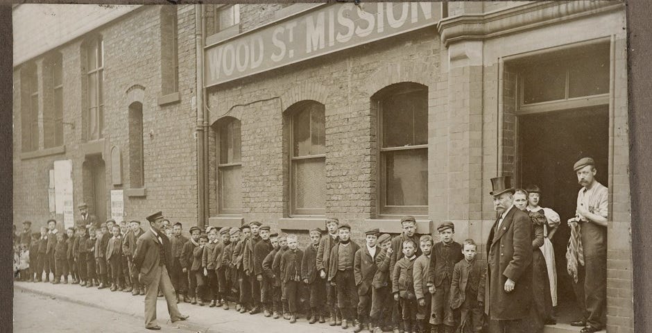 Photograph of a queue of children outside the Mission