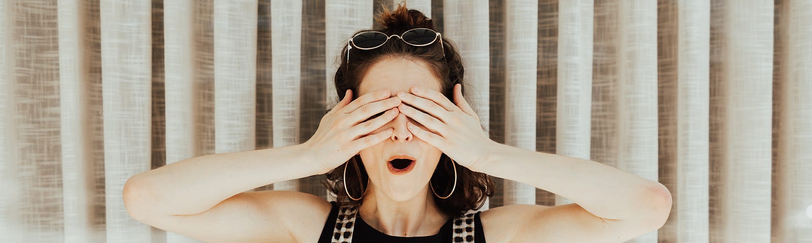 Woman covering eyes with hand because of the one content mistake she made