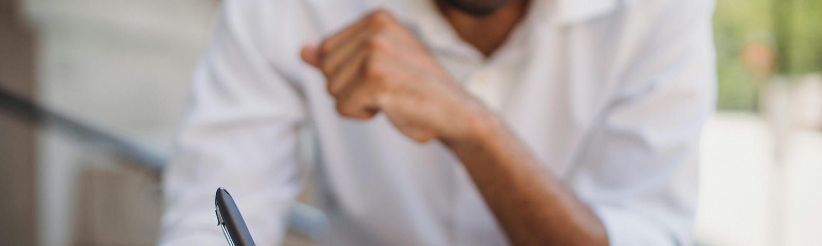 Shallow Focus Photo of a Person Writing on a Notebook