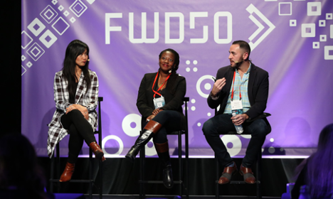 Panelists appear on bar stools from last year’s conference with a blue backdrop which reads FWD50 in big, bold white letters.