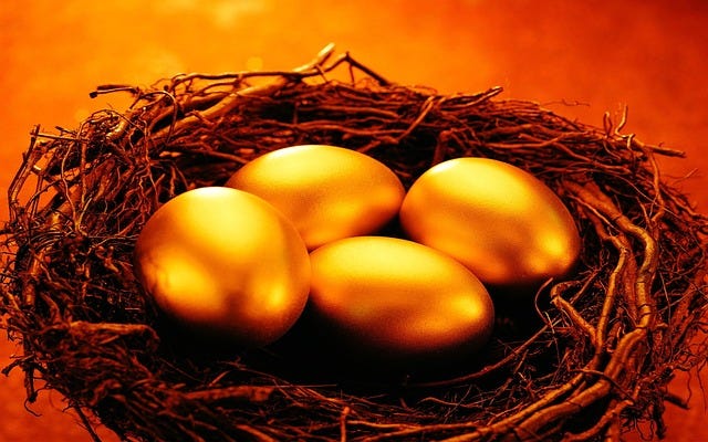 Four golden eggs in a nest