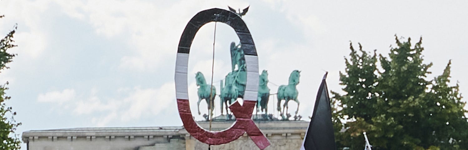 A Qanon sign in front of the Brandenburg Gate in Berlin, Germany.