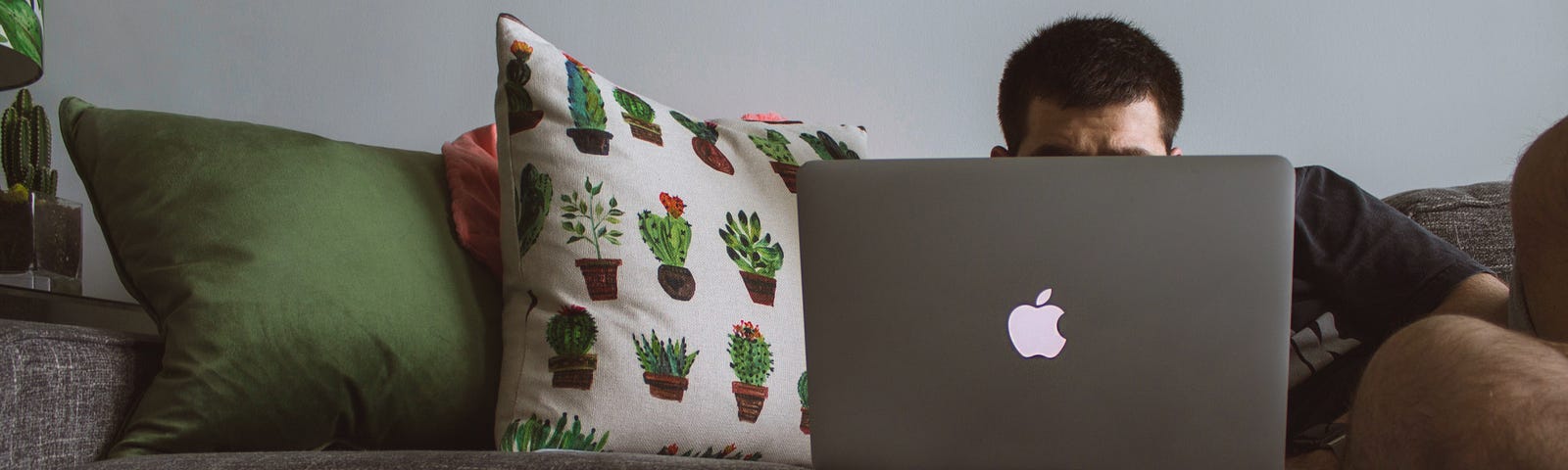 Remote employee, working on couch.