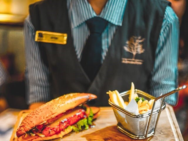 A waiter carrying food