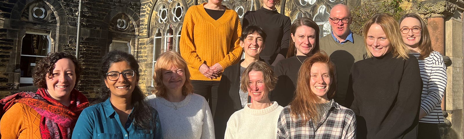 The Horizons Institute team stand together for a photo on the steps of Hinsley Hall in Headingley, Leeds