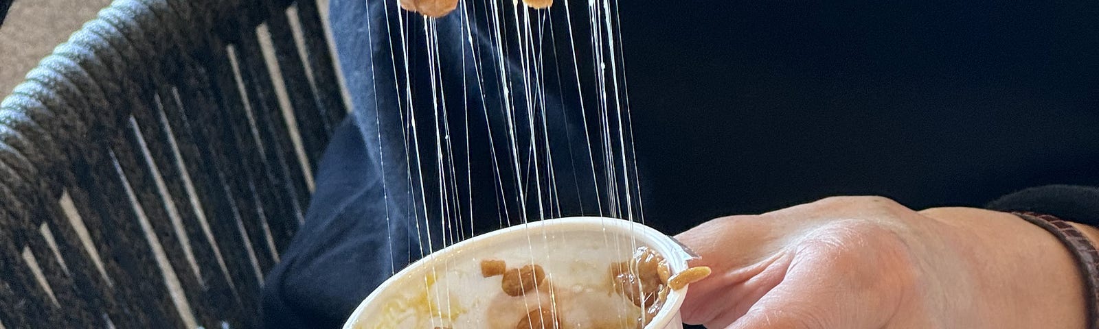 Natto being eaten from container using chopsticks